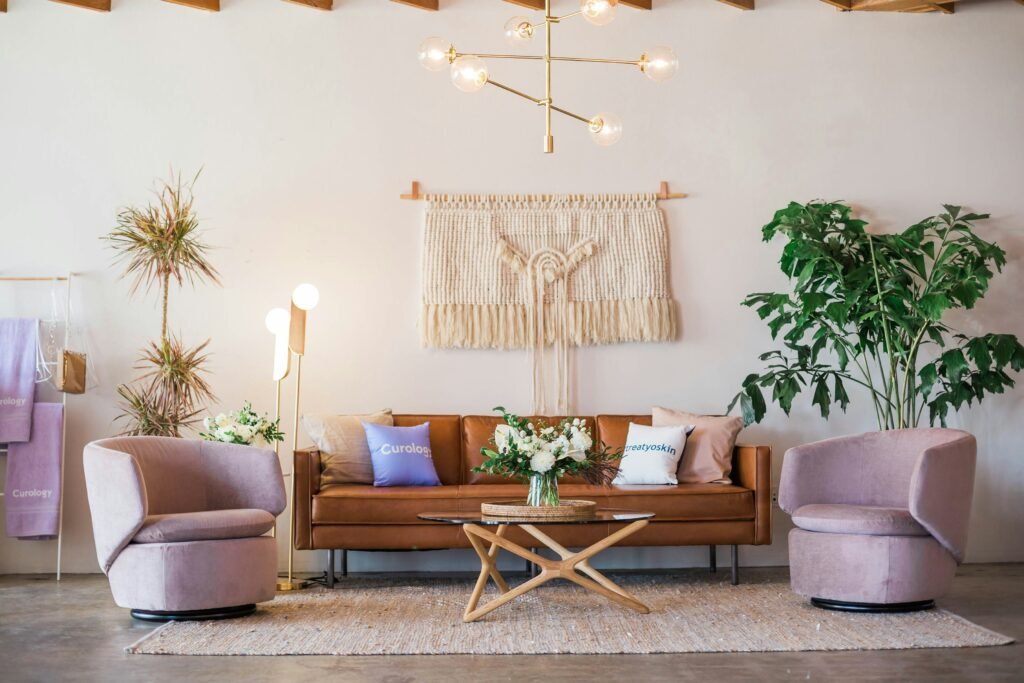 12 Popular Home Interior Design Types Explained (How to Find Your Style) a bohemian style living room interior with a large plant and woven macrame on the wall above the sofa
