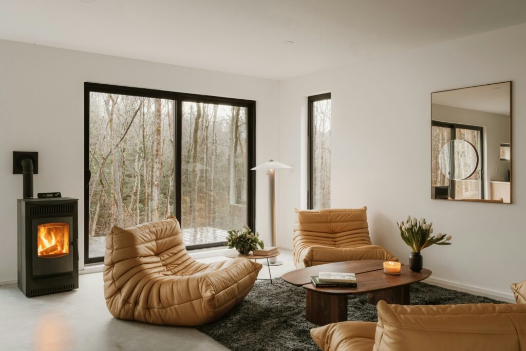 How to Create a Warm Minimalist Home: The Ultimate Design Guide warm minimalist living room with curved furniture in warm tones and a small fireplace